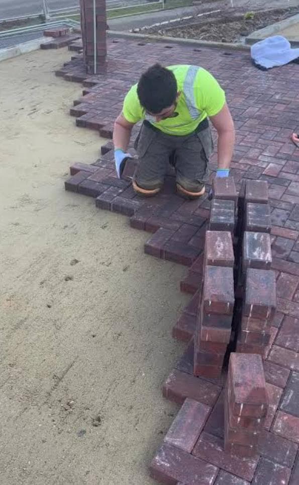 New brick pavers being laid on a compacted and levelled sub-base